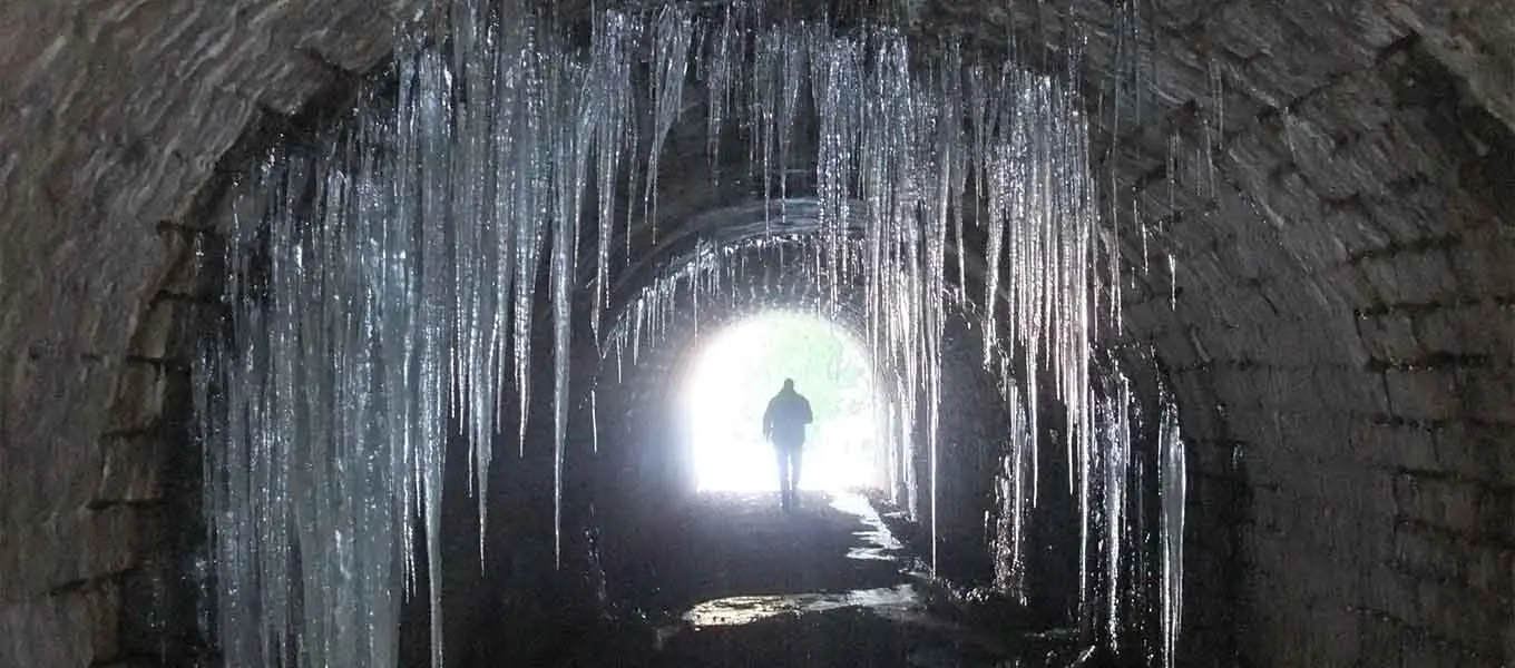 The 19th century coal tunnel pictured in winter with frozen water leaking from the Cascade above.