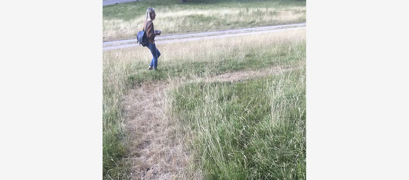 Hannah Wallace inspecting the parch marks of a demolished house