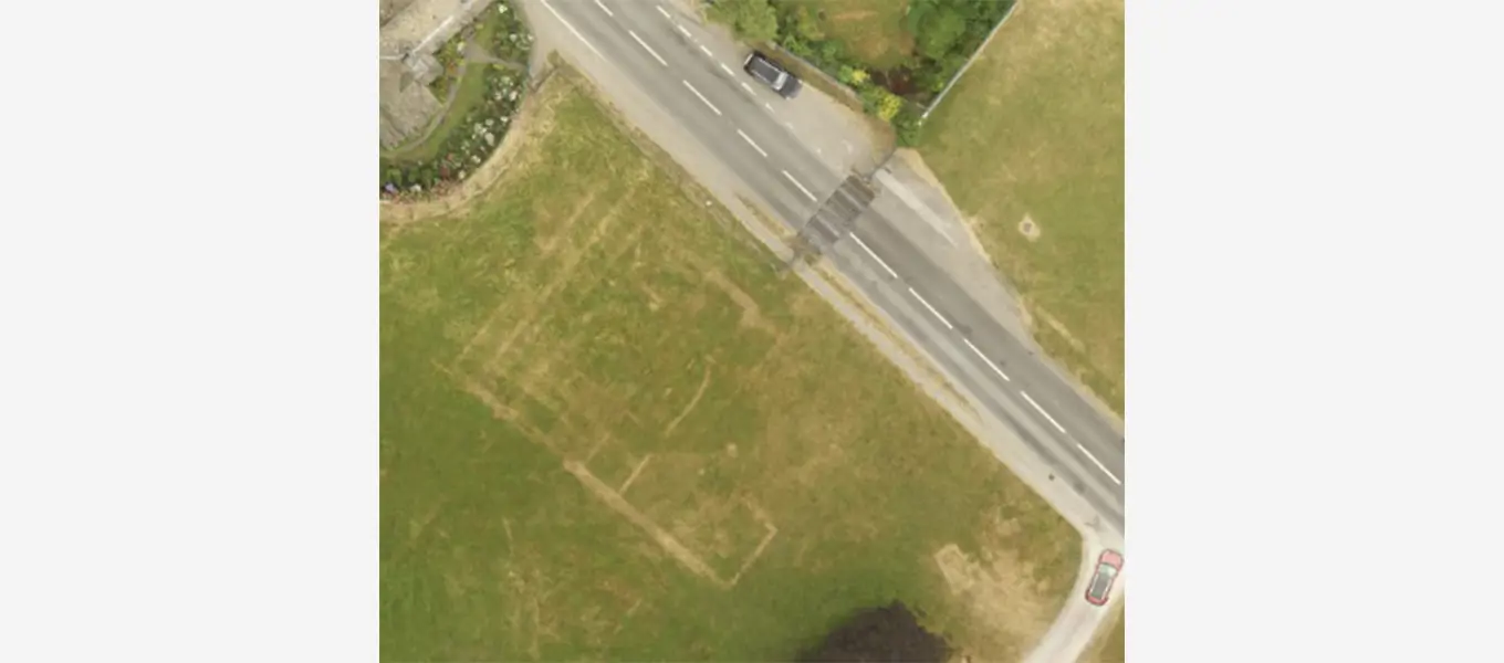 These parch marks next to the lodges at the entrance to the park reveal the outline of the old farm yard.