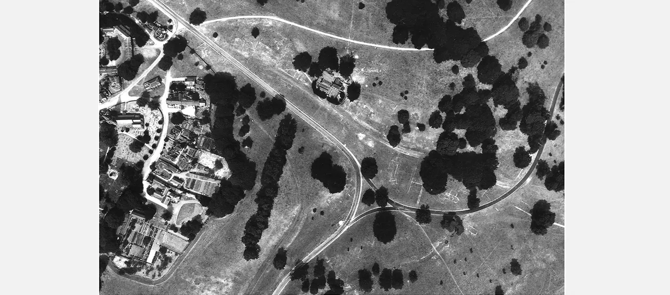 The white smudges and lines on this black-and-white aerial photograph from the 1940s show the outline of the old high street and its buildings, some of which can be matched up to this map from 1785.