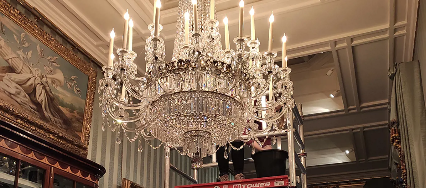 Preparing to remove and clean the chandelier in the South Sketch Gallery 