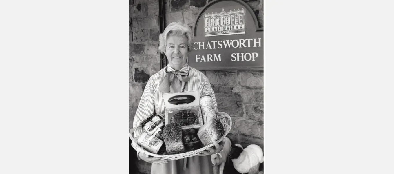 Duchess Deborah with a basket of produce from the estate farm shop